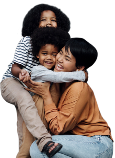Caring nanny laughing as she hugs two toddlers