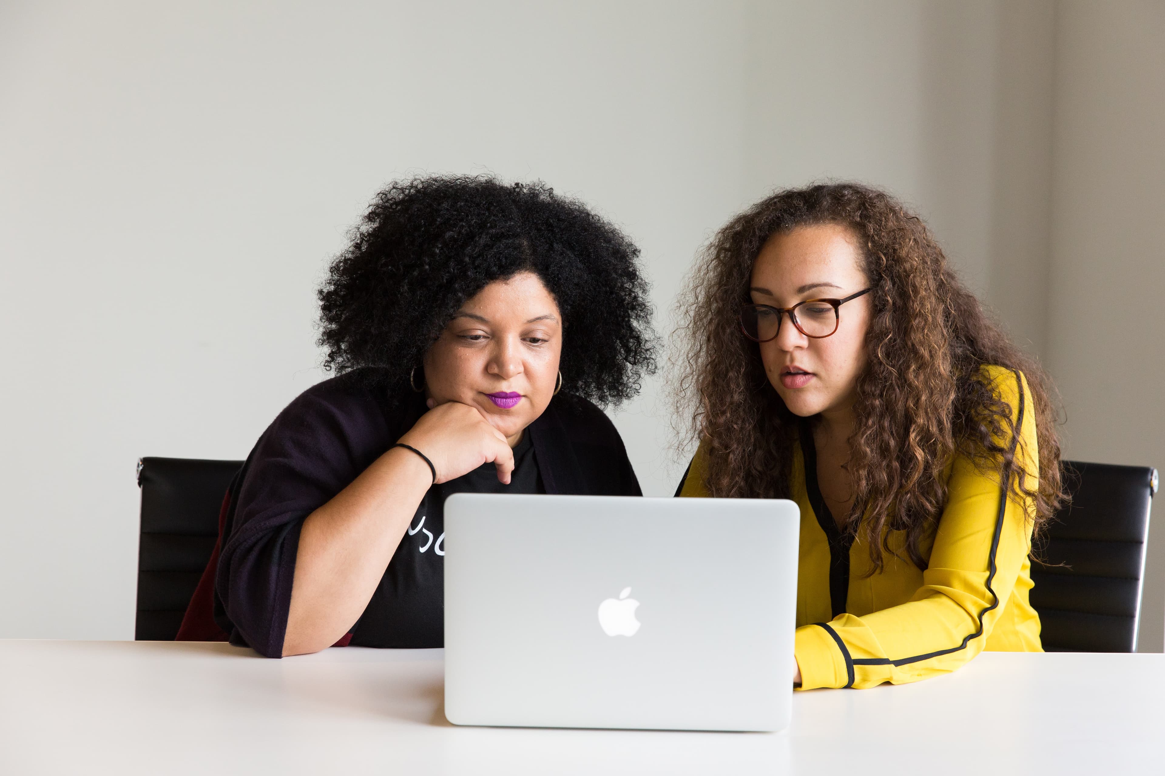 two adults sharing a computer screen