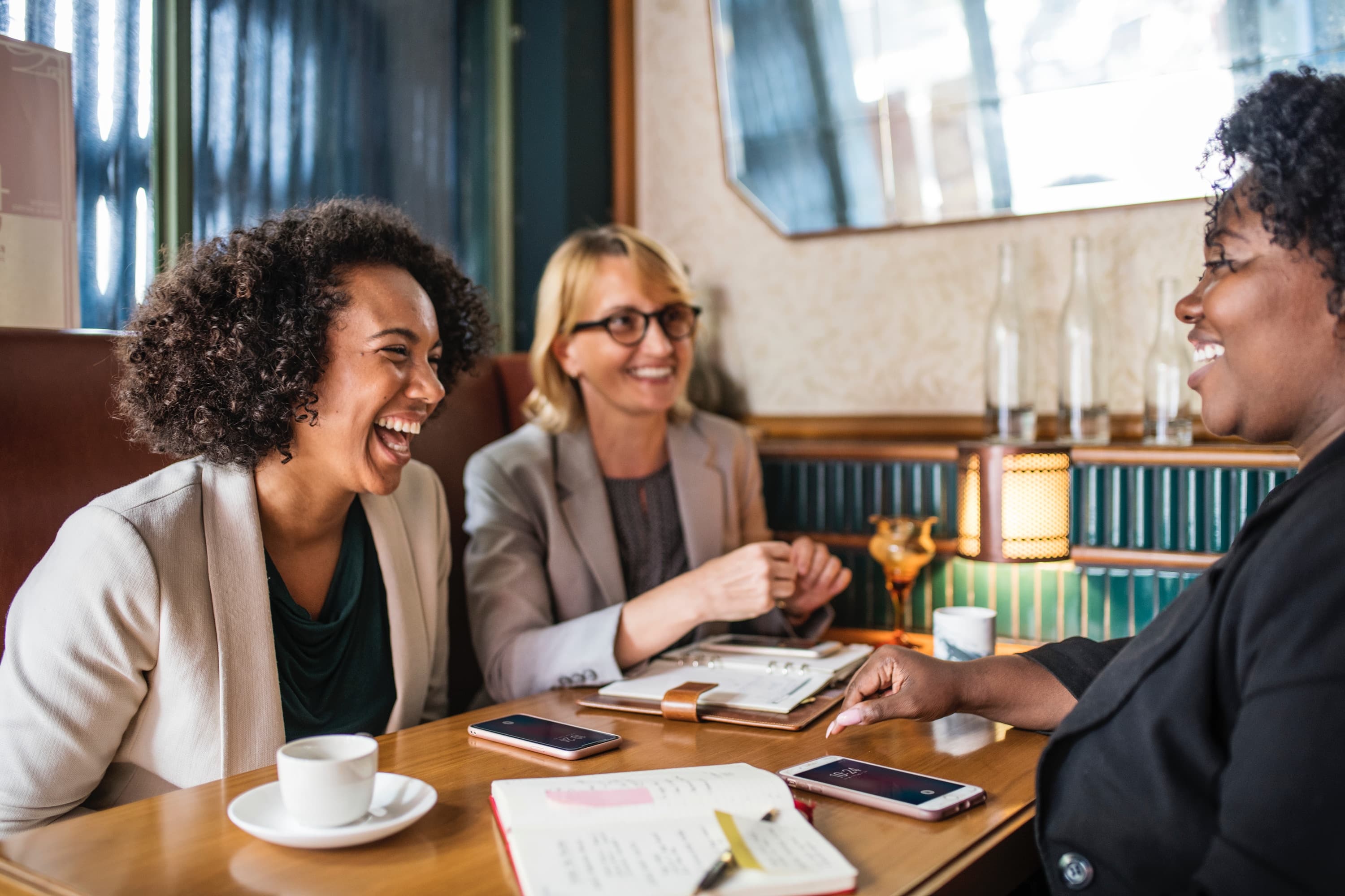 A group of women laughing around a table