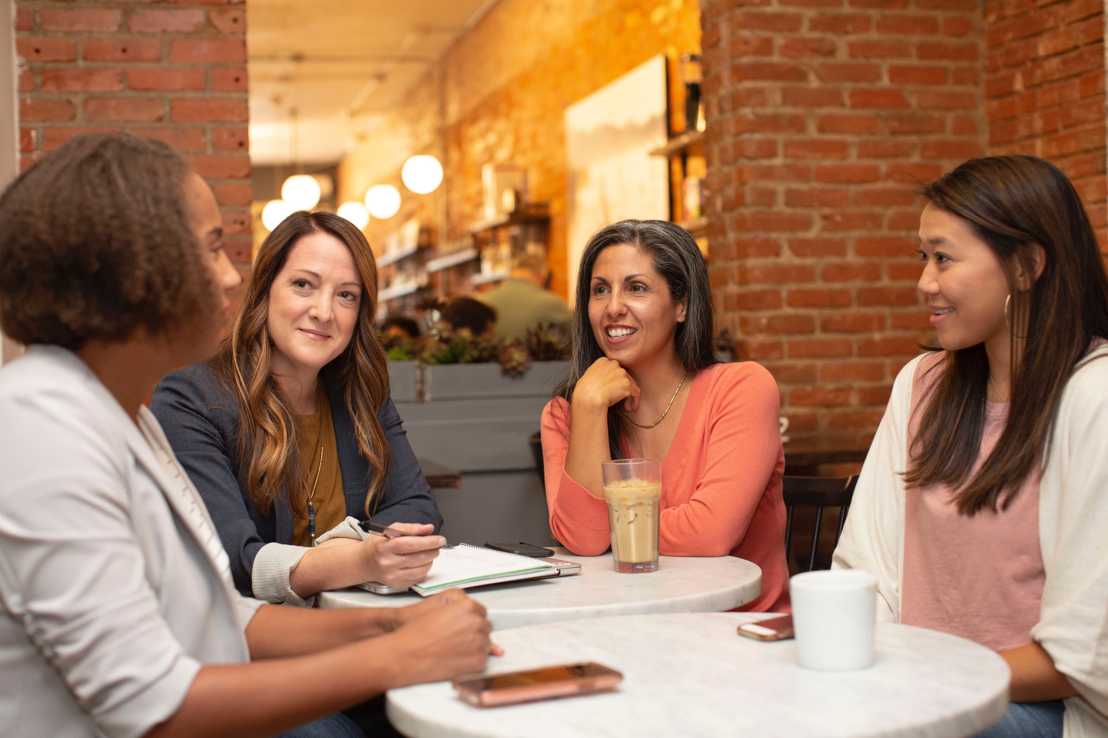A group of women sitting around a table 