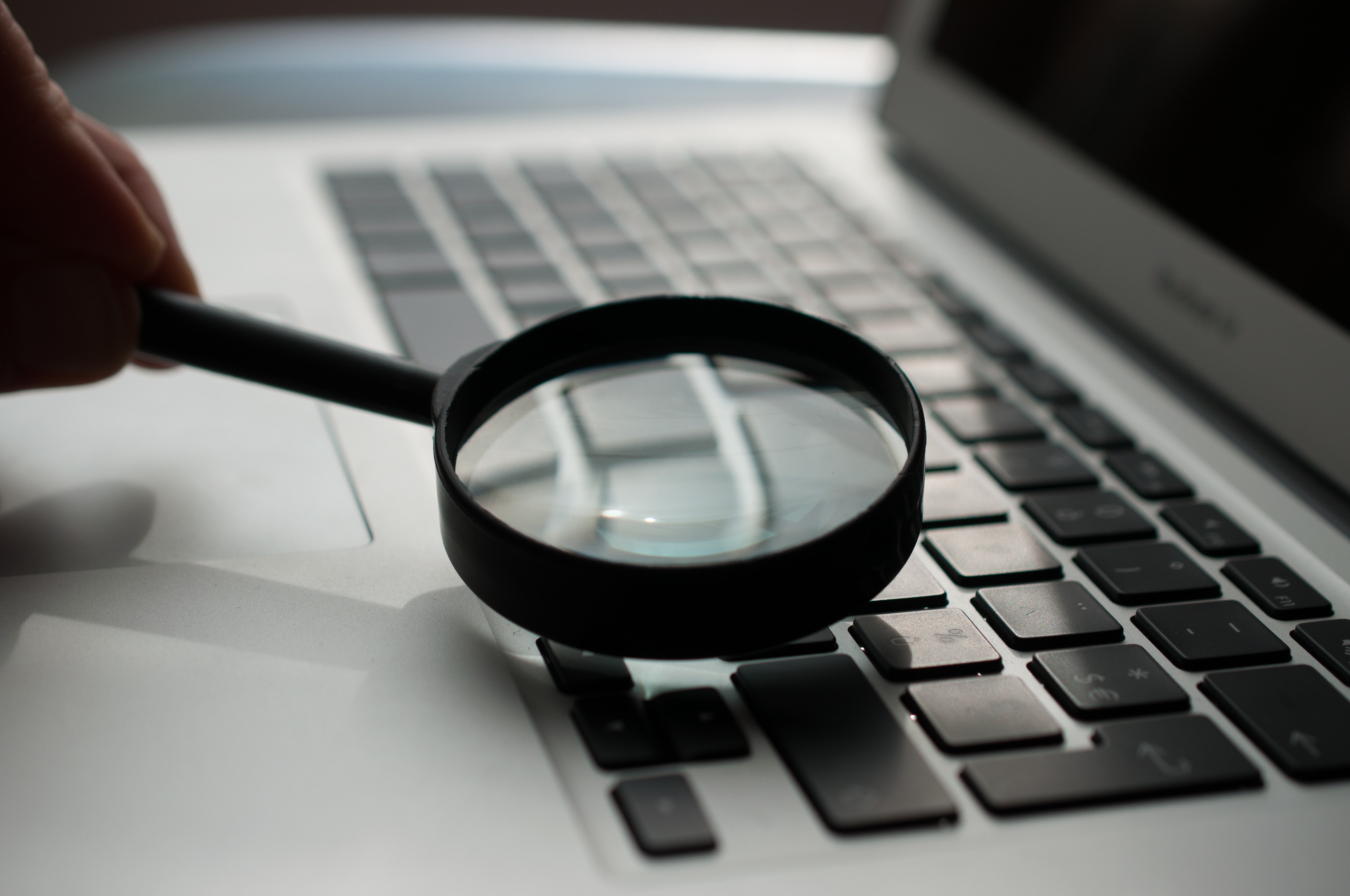 A magnifying glass and a laptop keyboard