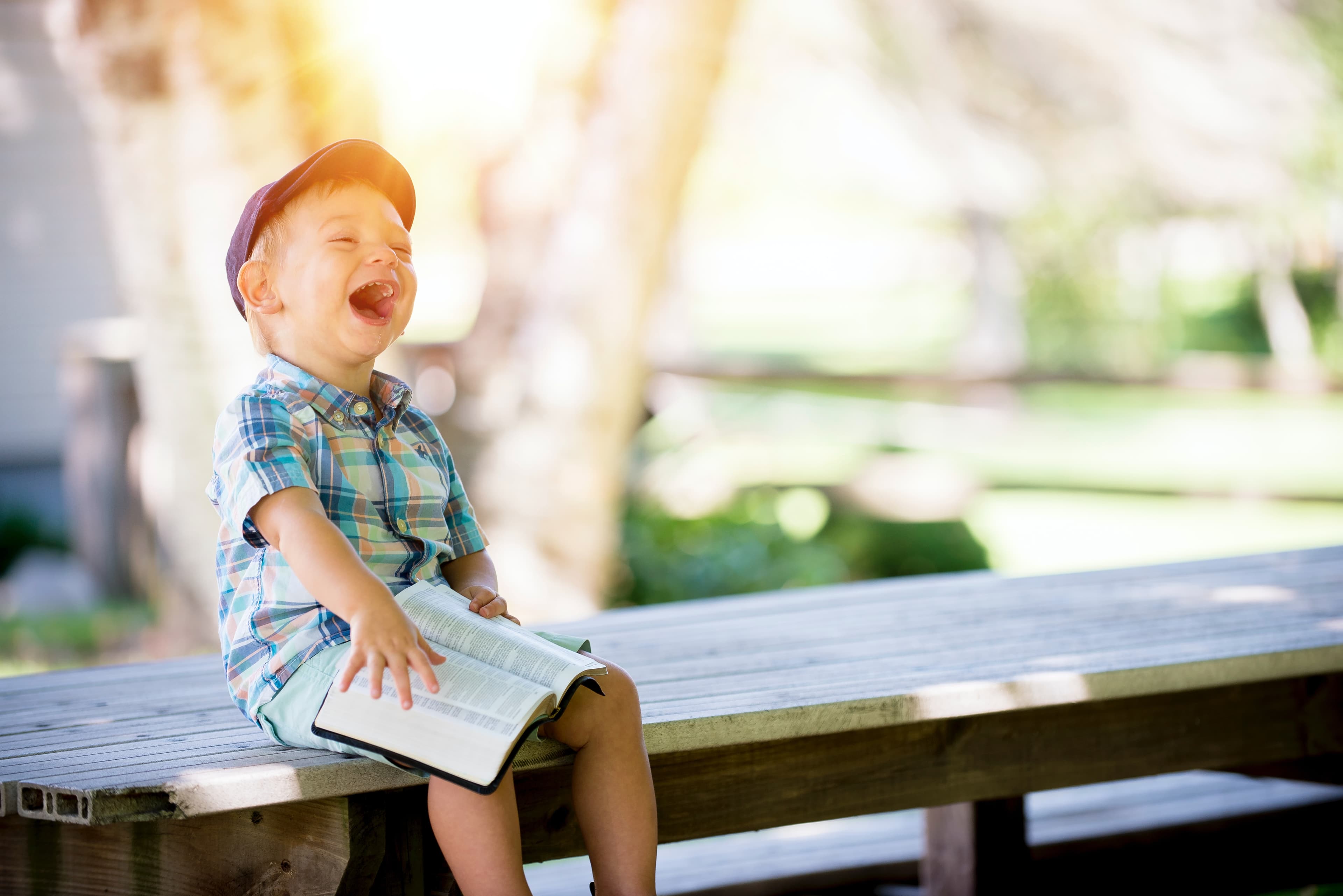 A child laughing in the sun